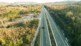Aerial view country road in forest clip: Drone flying over road in forest.