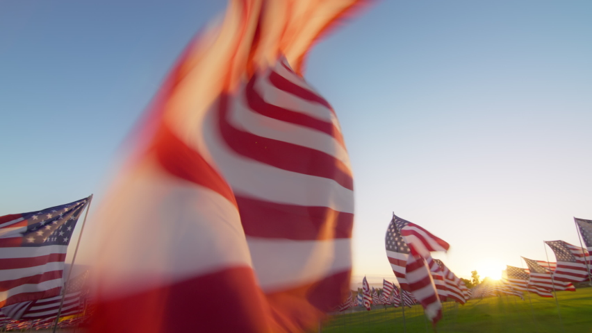 Close up American flag waving on sunset with soft focus sun flare. Slow Motion concept of Independence Day, Veterans Day, Memorial Day, 4th of July, Celebrate USA, American Election, America, Labor Royalty-Free Stock Footage #1095239183