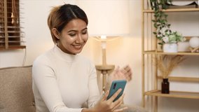 Beautiful Asian woman is video calling with her friend during her break from work, she is a startup marketing manager, female leader, supervisor, ceo. Female Leadership Concept.