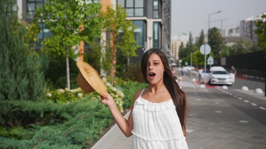 Young nice girl humorous posing a tube. Antics on camera.