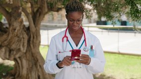 African american woman doctor smiling confident having video call at park