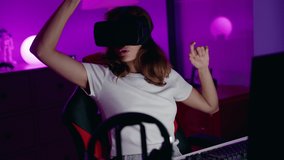 Young beautiful hispanic woman streamer playing video game using virtual reality glasses at gaming room
