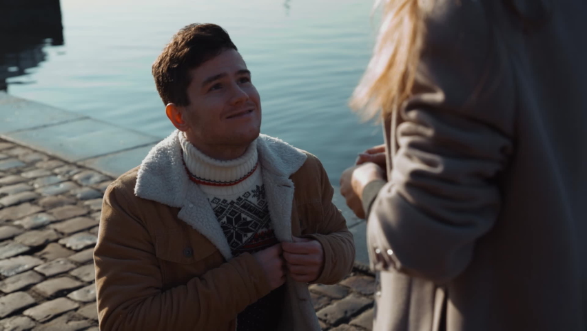 Young man proposes marriage to his beautiful girl, young women on vacation in Europe. Valentine