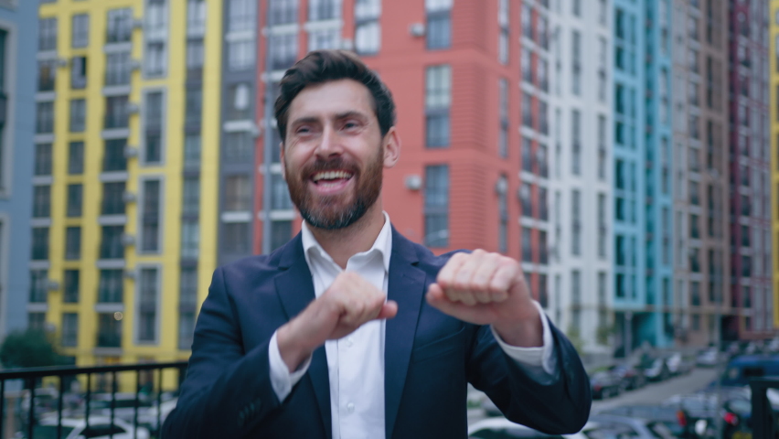 Happy businessman having fun after hard day celebrating victory male caucasian winner bearded man in suit dancing alone outdoors enjoy successful business deal get career growth achievement in company Royalty-Free Stock Footage #1095267973