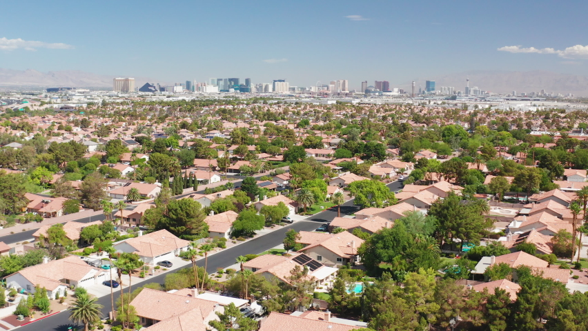 Aerial shot of Las Vegas residential homes with casino strip skyline and airport Royalty-Free Stock Footage #1095271063