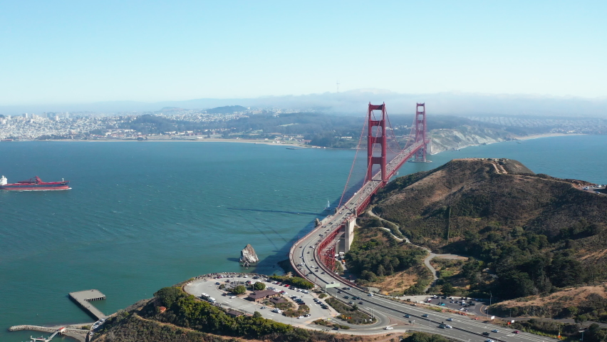 Aerial shot of Golden Gate Bridge and boat and car traffic in San Francisco Bay