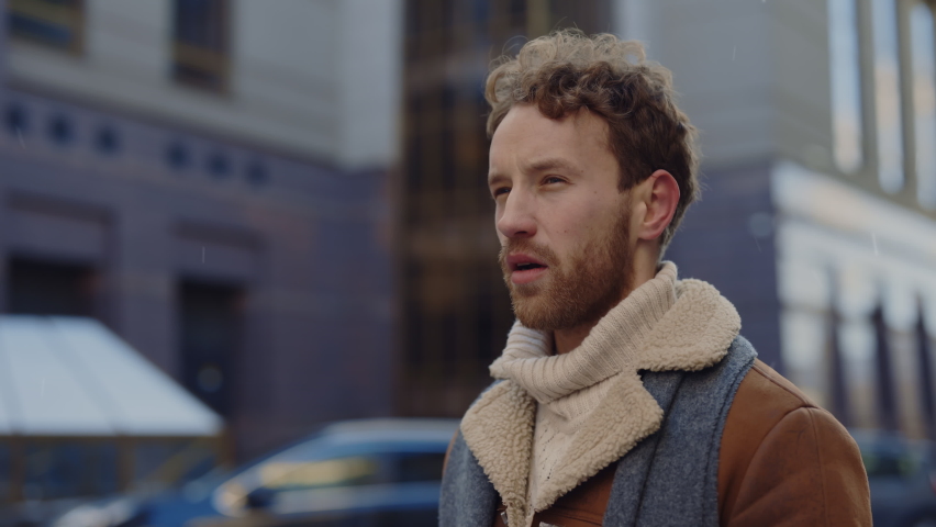 Caucasian man with beard in scarf blowing his nose into handkerchief while standing outdoors. Man feeling sick blowing nose using handkerchief. People and health problems concept Royalty-Free Stock Footage #1095273109