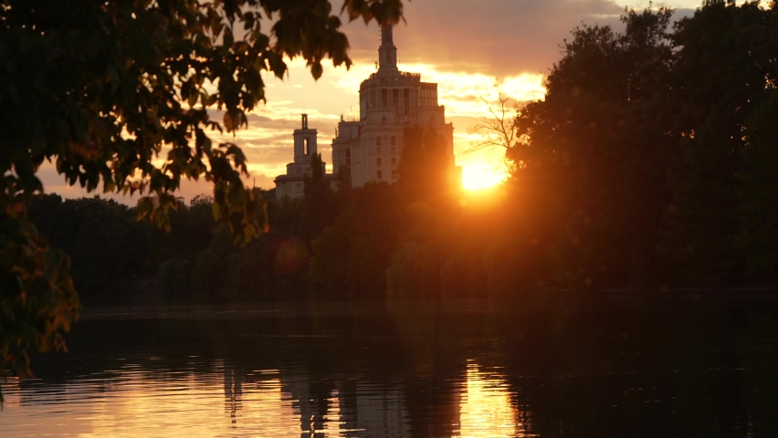 4K video, autumn sunset over Free Press House (Casa Presei Libere in Romanian language) and Herastrau Park lake. Travel to Romania, amazing landscape in the heart of Bucharest, 2022.