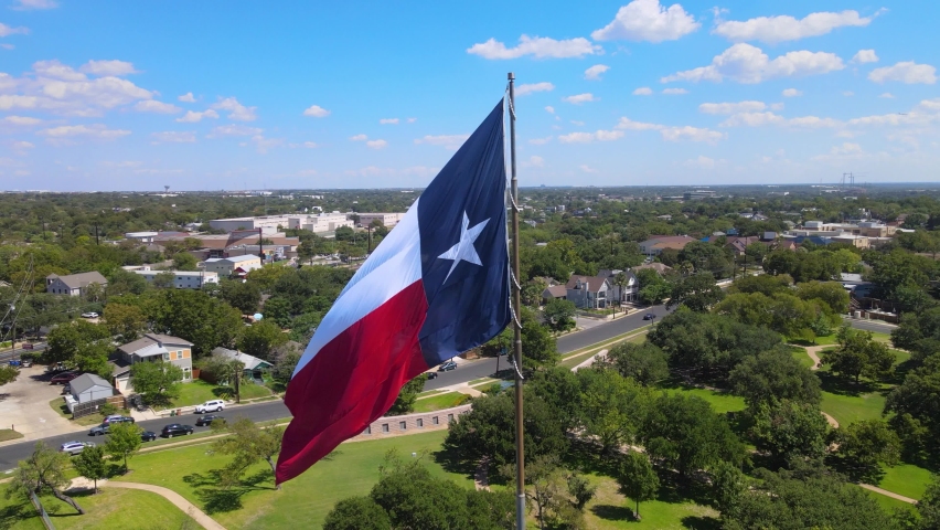 Orbital shot of Texas Flag with the city of Austin, Texas in the background.