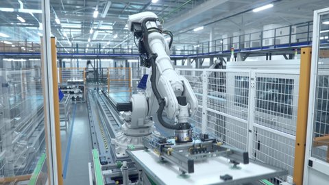 White Industrial Robot Arm at Production Line at Modern Bright Factory. Solar Panels are being Assembled on Conveyor. Automated Manufacturing Facility Adlı Stok Video