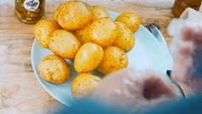 Woman peeling a potato with sharp knife. Kitchen food video, peeling skin of fresh potatoes. female preparing food for a meal