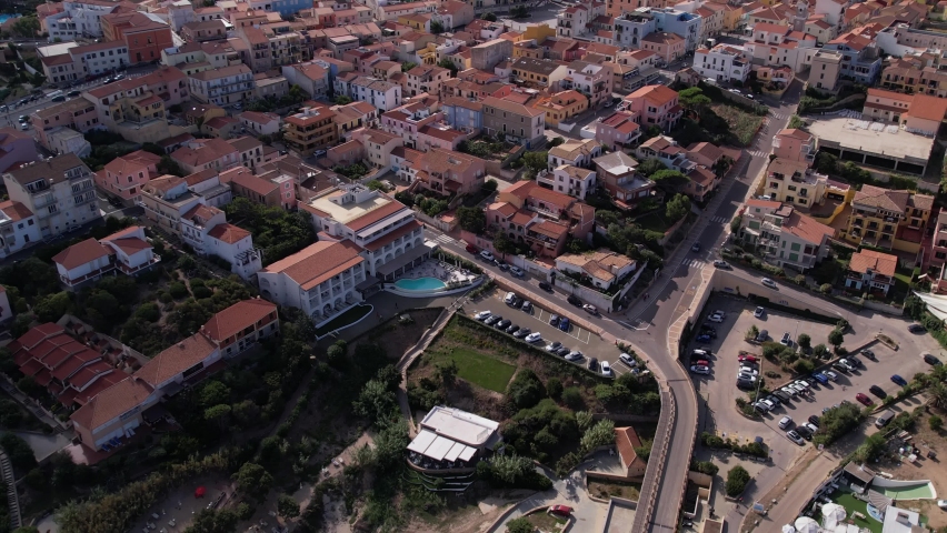 Aerial Flying Over Housing In Santa Teresa Di Gallura Town With Tilt Up Reveal Of Sardinian Landscape In The Background 
