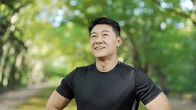 Close up portrait young happy asian man standing in nature between forest trees relaxes, breathes fresh air closing his eyes. Male enjoys a life of peace calm, quiet in the park. Outdoors. Happiness - Powered by Shutterstock - Get 15% off with code: PIKWIZARD15