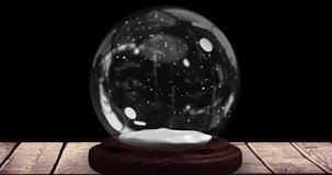 Animation of christmas snow globe with christmas tree on black background. Christmas, fesivity, celebration and tradition concept digitally generated video.