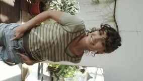 Vertical multi footage with seamless transition of beautiful girl smiling and showing new outfits after covering camera with hand while recording dress change video for social media - Powered by Shutterstock - Get 15% off with code: PIKWIZARD15