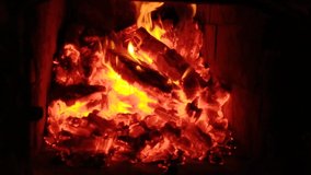 Calming fireplace with burning wood in a cold house