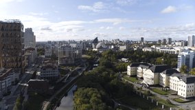 A daytime living city with a bright light. The view from the drone. Stock footage.Tall buildings in the city center with big traffic jams and beautiful architectural buildings.