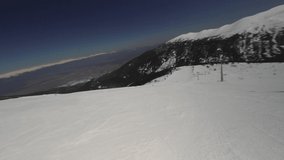 HYPERLAPSE Skiing. Action camera of skier going downhill on alpine ski on snow slopes in the mountains. Man going downhill on ski having fun on slopes. Winter sport outdoor activity video
