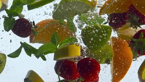 Floating fresh organic fruits underwater in super slow motion close up. Tasty sliced banana kiwi orange strawberry mint dropped in water raising up with bubbles. Healthy organic food concept. - Powered by Shutterstock - Get 15% off with code: PIKWIZARD15