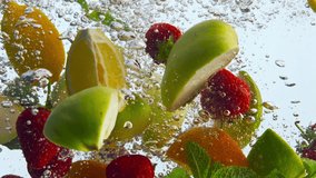 Closeup pieces fruit submerged clean water on white background. Juicy organic strawberry orange apple lemon mint floating with bubbles in super slow motion. Tasty vitamin food for healthy nutrition. - Powered by Shutterstock - Get 15% off with code: PIKWIZARD15