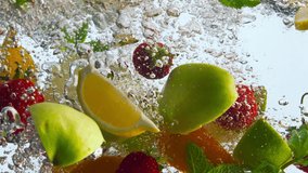 Sliced various fruits dropped transparent liquid on white background close up. Fresh delicious ingredients for lemonade falling water in super slow motion. Organic orange apple strawberry underwater. - Powered by Shutterstock - Get 15% off with code: PIKWIZARD15