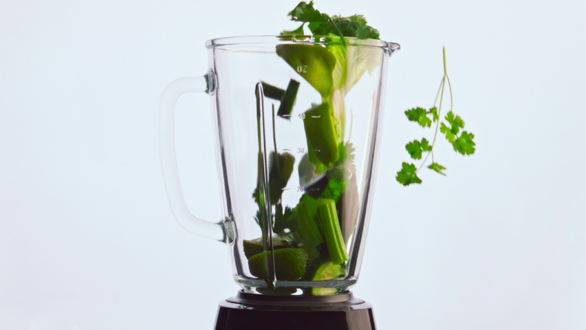 Blender with ingredients close up on white background. Celery