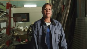 Medium portrait of Biracial female mechanic posing with hands folded at factory - Powered by Shutterstock - Get 15% off with code: PIKWIZARD15