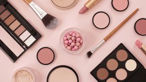 A set of decorative cosmetics on pink background. Makeup products. The beauty of the background with cosmetic facilities. Makeup, the concept of skin care with. High quality 4k footage