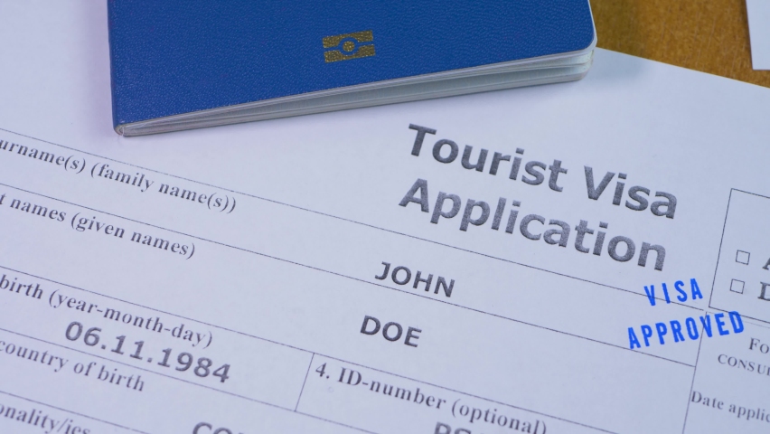 Approved tourist visa decision. Stamp in application form with passport and blue pen. Apply and permission for foreigner country. Success interview in embassy  Royalty-Free Stock Footage #1095308459