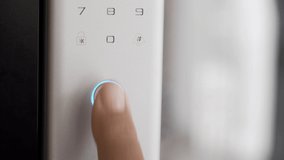 Close Up Footage of Man's hand opens the electronic digital door with a finger scan to access the home security system
 - Powered by Shutterstock - Get 15% off with code: PIKWIZARD15