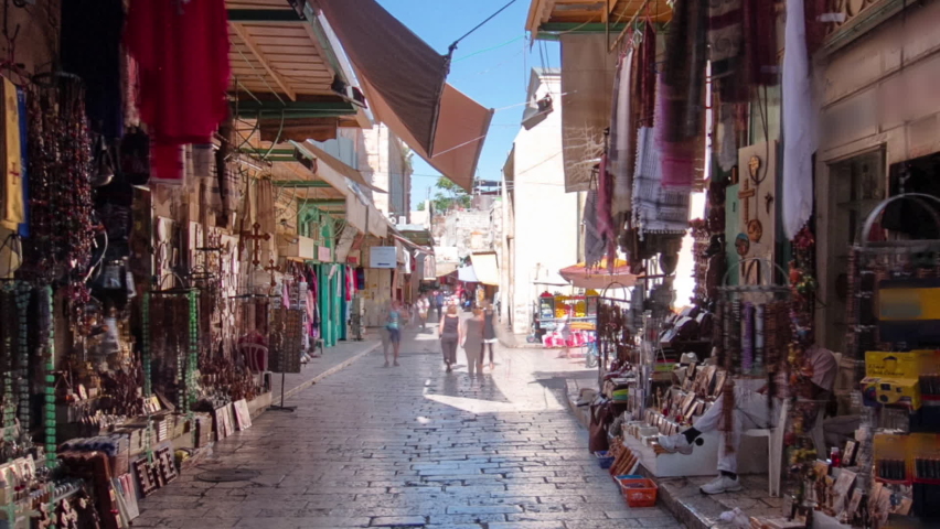 The colorful souk near Holy Sepulchre in the old city of Jerusalem Israel timelapse hyperlapse. Crowd of people passing by on this makret