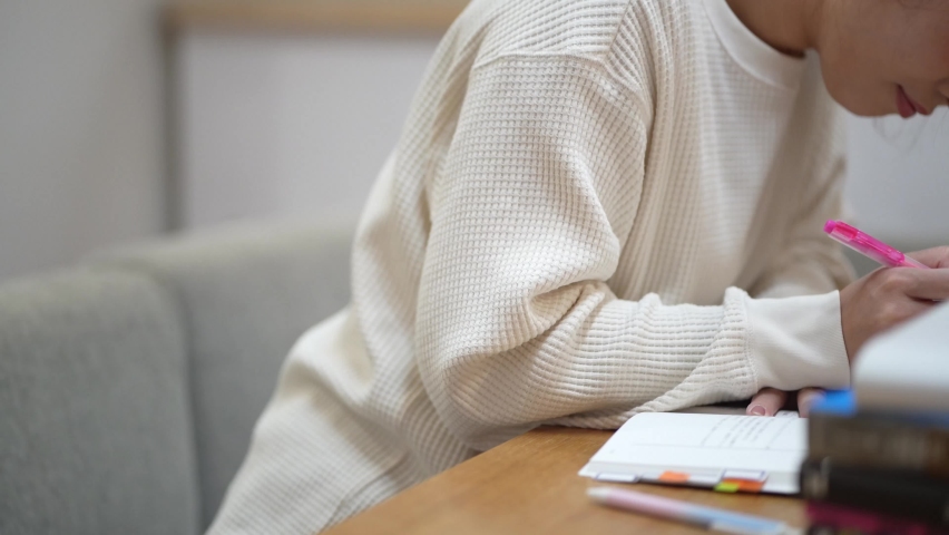 Image of a woman studying at home
