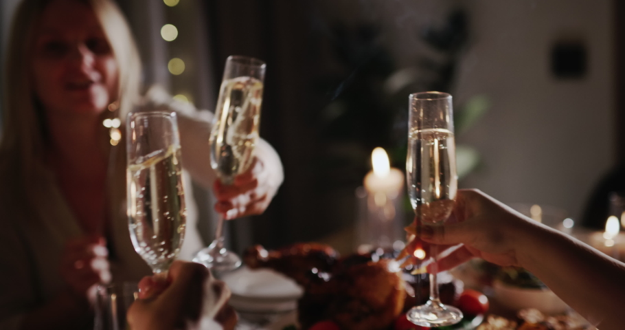 The family clinks glasses over the festive table, holds sparklers in their hands Royalty-Free Stock Footage #1095327475