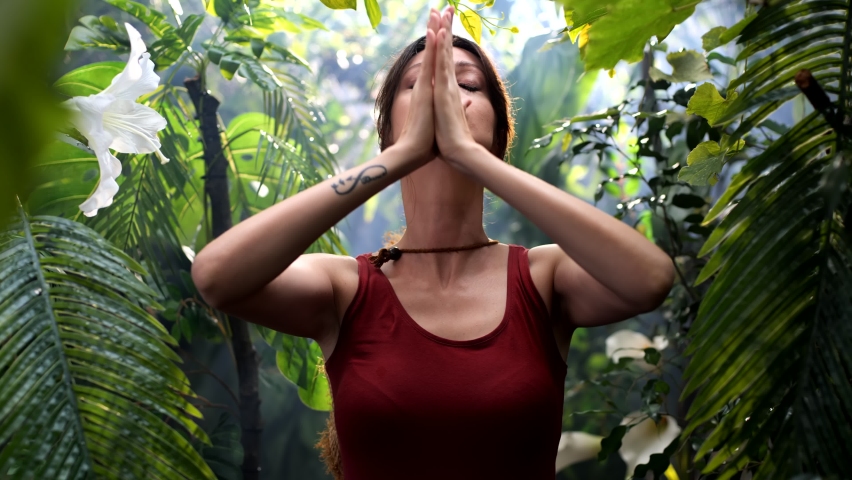 Woman practicing breathing yoga pranayama outdoors in rainforest Royalty-Free Stock Footage #1095327673