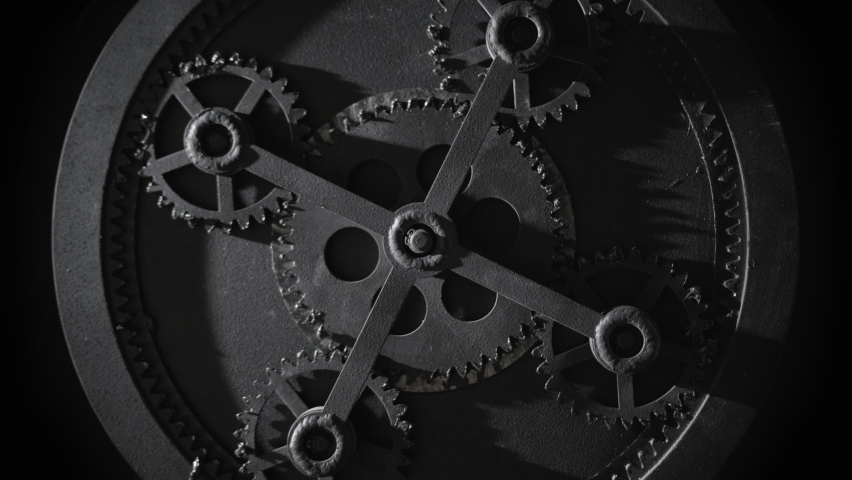 Mechanism with five rotating gears. Retro vintage cogwheels of machine in ancient old factory. Moving engine parts and internal details, steampunk concept. Isolated on black, zoom in Royalty-Free Stock Footage #1095328281