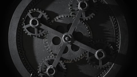 Стоковое видео: Mechanism with five rotating gears. Retro vintage cogwheels of machine in ancient old factory. Moving engine parts and internal details, steampunk concept. Isolated on black, zoom in