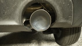 4K: Towards Exhaust Pipe on a Car emitting smoke fumes and pollution. Probe Lens Inside. Stock video clip footage