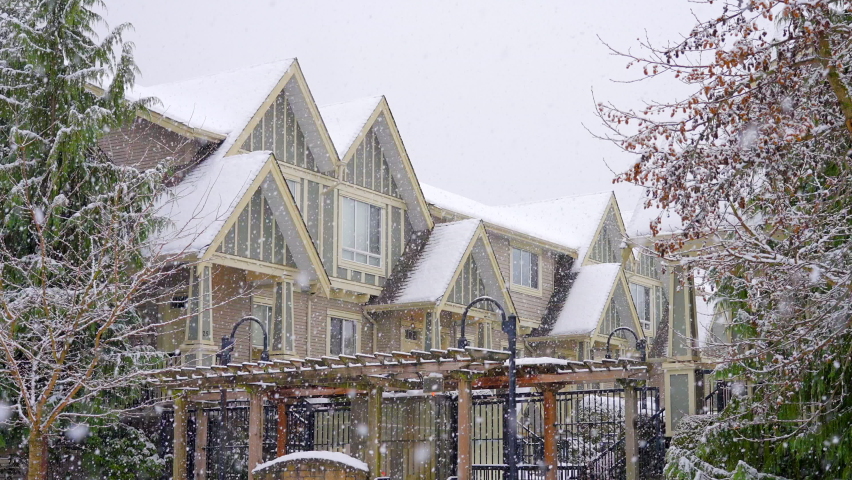 Establishing shot of modern apartment building with beautiful winter snowfall landscape in Vancouver, Canada, North America. Day time on December 2021. ProRes 422 HQ.