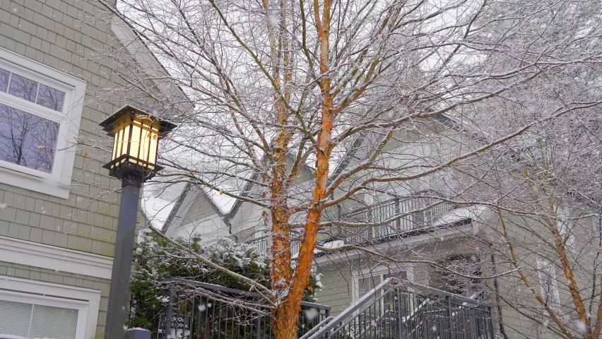 Establishing shot of modern apartment building with beautiful winter snowfall landscape in Vancouver, Canada, North America. Day time on December 2021. ProRes 422 HQ.