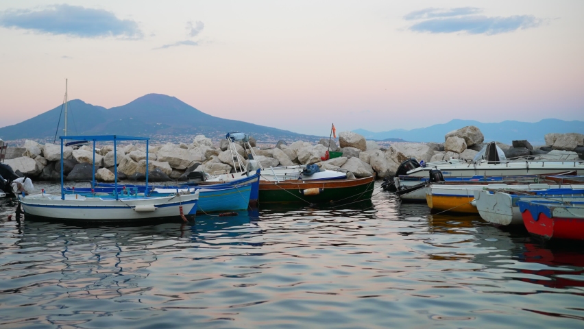 Fishing boats against the backdrop of Mount Vesuvius in Naples. Royalty-Free Stock Footage #1095336469