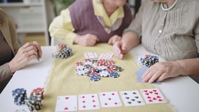 Positive senior women playing poker together, winning the game, girls night - Powered by Shutterstock - Get 15% off with code: PIKWIZARD15