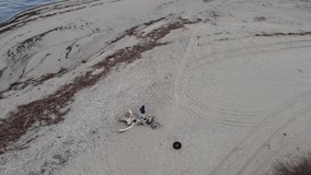 Drone perspective on a dirty beach.