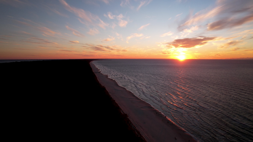 Aerial Dramatic Colorful Sunset over Baltic Sea Horizon Level from Krynica Morska spit, Poland