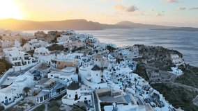 Santorini island in Greece, aerial view of famous Oia town on Santorini at sunrise, Greek tourist destination, windmill in Oia, Santorini. High quality 4k footage - Powered by Shutterstock - Get 15% off with code: PIKWIZARD15