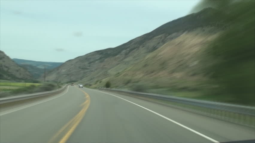 Driving through Wyoming roads surrounded by mountains in time lapse 11.