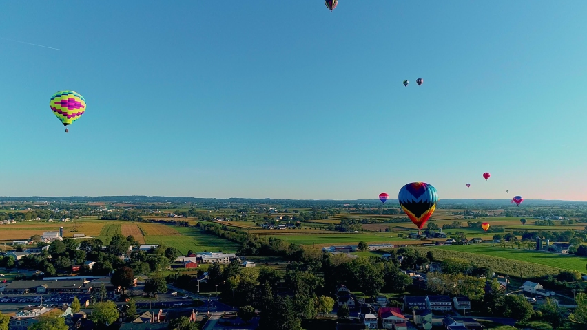 Drone View of a Multiple Hot Air Balloons Floating in the Sky During a Balloon Festival on a Sunny Day