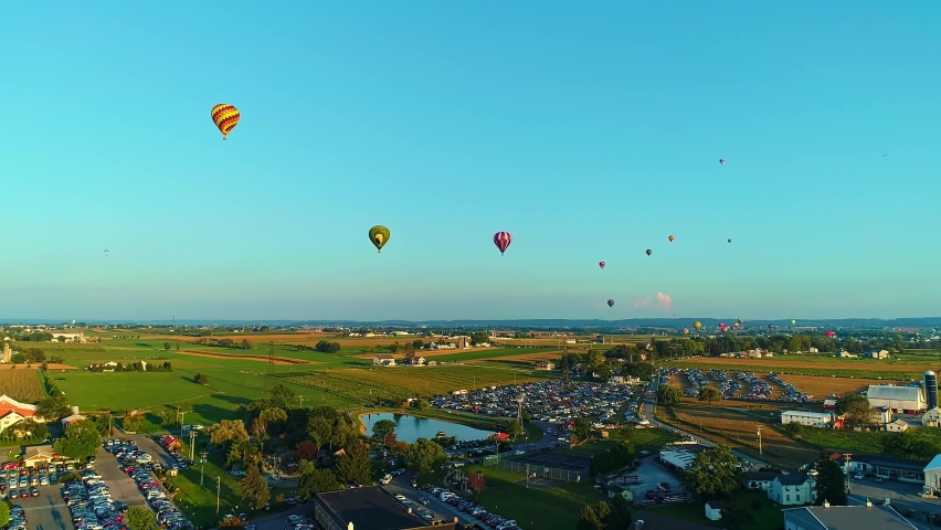 Drone View of a Multiple Hot Air Balloons Floating in the Sky During a Balloon Festival on a Sunny Day