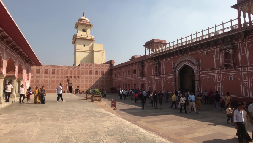 Jaipur, India - November 04, 2019: City Palace Square with tourists against the backdrop of a clock tower