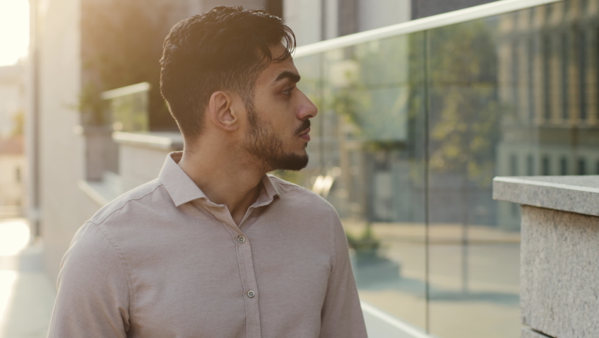 Portrait male man guy businessman employer thinking walks street looking at windows of city building. Hispanic bearded pensive entrepreneur walking outdoors thinks looking to side Latina tourist going Royalty-Free Stock Footage #1095382277