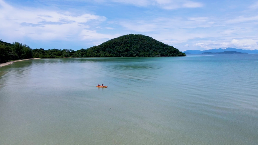 Couple of Men and women in a Kayak peddling in the turquoise-colored ocean of the tropical Island of Koh Mak Thailand